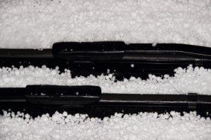 Windshield wiper with white hail in winter
