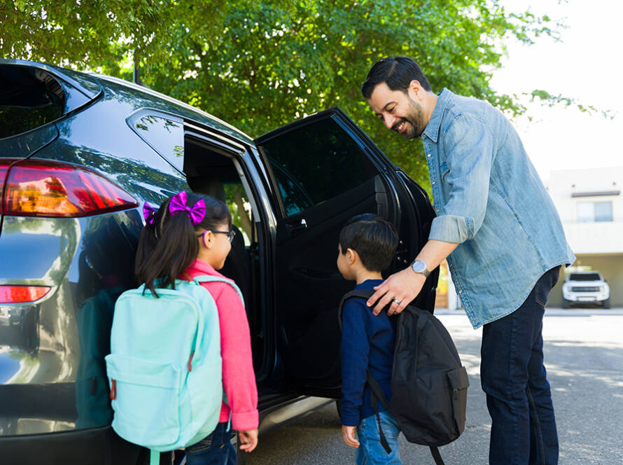 Father and children pile into the car to head back to school